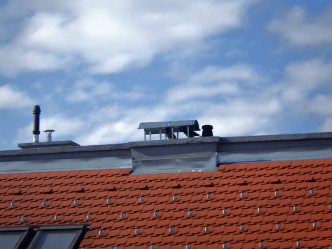 the roof of a building with a couple of chimneys